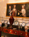 Detail of side board with China & serving dishes under family portrait typical of the era at Georgian House Museum. Bristol, England.