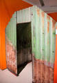 Anderson shelter, made of corrugated steel, used during WWII & distributed to home owners as "backyard" bomb shelters which were half-buried in ground & covered over with earth at M-Shed Museum. Bristol, England.