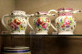 Earthenware puzzle jugs with bold floral designs made at Bristol Pottery factory at Bristol Museum & Art Gallery. Bristol, England.