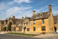 Streetscape of heritage buildings constructed in honey colored stone. Broadway, England