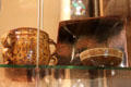 Earthenware & glazed drinking cup by Michael Cardew, stoneware square dish by Ray Finch & earthenware bowl by Sidney Tustin at Court Barn Museum. Chipping Campden, England.