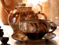 Earthenware teacup & saucer & earthenware teapot both by Michael Cardew at Court Barn Museum. Chipping Campden, England.