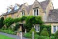 Homes along bank of River Eye. Lower Slaughter, England.
