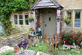 Home with profusion of plantings in front garden. Lower Slaughter, England.