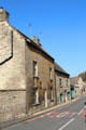 Vintage building on High Street with S-shaped supports to keep stone facade from bowing outward. Northleach, England.