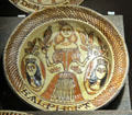 Slip decorated dish prob. showing Princes Mary holding tulip between side portraits of husband William of Orange & father James II by Ralph Toft of North Straffordshire at Potteries Museum & Art Gallery. Hanley, Stoke-on-Trent, England.