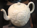 Cream colored earthenware teapot with sprigs made in Straffordshire at Potteries Museum & Art Gallery. Hanley, Stoke-on-Trent, England.