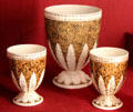 Earthenware gold & white neoclassical vases impressed Wedgwood of Etruria, at Potteries Museum & Art Gallery. Hanley, Stoke-on-Trent, England.