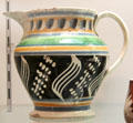 Earthenware jug with slip decoration by Enoch Wood & Sons of Burslem, Staffordshire at Potteries Museum & Art Gallery. Hanley, Stoke-on-Trent, England.