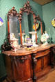 Collection of showpiece Minton of Stoke vases on elaborately carved sideboard with mirror at Potteries Museum & Art Gallery. Hanley, Stoke-on-Trent, England.