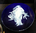 Porcelain plaque with white figure on blue ground by T.C. Brown-Westhead for Moore & Co. of Hanley, Staffordshire at Potteries Museum & Art Gallery. Hanley, Stoke-on-Trent, England.