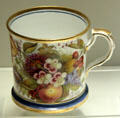 Example of over-glaze hand painting on bone china mug from Staffordshire at Potteries Museum & Art Gallery. Hanley, Stoke-on-Trent, England.