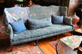 Bird jacquard-woven wool fabric on winged mahogany sofa with undulating top rail by Morris & Co in Great Parlor at Wightwick Manor. Wolverhampton, England.