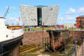 Titanic Belfast building over dry dock & display ships in restored Titanic Quarter. Belfast, Northern Ireland.