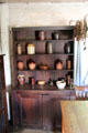 Sideboard with crockery in Pennsylvania Log Farmhouse at Ulster American Folk Park. Omagh, Northern Ireland.