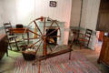 Spinning wheel & chairs in Pennsylvania Log Farmhouse at Ulster American Folk Park. Omagh, Northern Ireland.