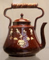 Red & white earthenware tea kettle with molded decoration made in Staffordshire at British Museum. London, United Kingdom.