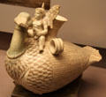 Faience vase in form of Eros riding a goose from tomb in Tanagara, Boeotia perhaps made in Egypt at British Museum. London, United Kingdom.