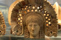 Etruscan-Latin painted terracotta antefix molded with head of woman in elaborate frame from Lanuvium, Latium at British Museum. London, United Kingdom.