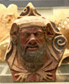 Etruscan painted terracotta antefix molded with head of man with beard 400-300 BCE) from Italy at British Museum. London, United Kingdom