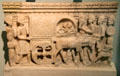 Etruscan carved alabaster cinerary urn front panel of chest with couple riding on covered wagon from Volterra at British Museum. London, United Kingdom.