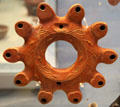 Roman terracotta multi-nozzle ring-shaped oil lamp decorated with myrtle-wreath made in Italy, found in Libya at British Museum. London, United Kingdom.