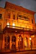 Italianate commercial building with covered sidewalk in Old Sacramento at night. Sacramento, CA.