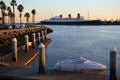 Queen Mary in light of sunset from Long Beach park. Long Beach, CA.