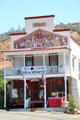 Sherlocks warehouse with mural depicting early days in Coulterville. Coulterville, CA.