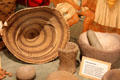 Native American basket & bowl mortars used for preparing acorn flour & pounding seeds at El Dorado County Historical Museum. Placerville, CA.
