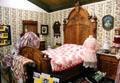 Ornately carved wooden Victorian bedstead & quilts at El Dorado County Historical Museum. Placerville, CA.