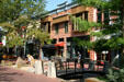 Heritage buildings along Pearl Street Mall with landscaped bridge over boulder arrangement. Boulder, CO.