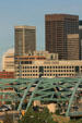 Steel arches of Speer Boulevard Bridge with Denver skyline. Denver, CO.