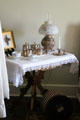 Table with lamp & coffee set at McAllister House Museum. Colorado Springs, CO.