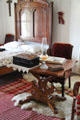 Bedroom table with oil lamp at Baca Adobe House. Trinidad, CO.