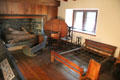 Upstairs east chamber with cradle, fold-down hutch table & rope bed at Henry Whitfield State Museum. Guilford, CT.