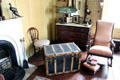 Bedroom with rocking chair & trunk at Butler-McCook House Museum. Hartford, CT.