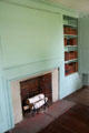 Fireplace with large wooden panel & bookcase at Oliver Ellsworth Homestead Museum. Windsor, CT.