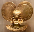 Gold ornament of human with earrings from Restrepo, Colombia at National Museum of the American Indian. Washington, DC.