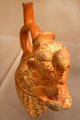 Moche ceramic stirrup-spout bottle figure of Wrinkle Face with bird headdress from Peru at Dumbarton Oaks Museum. Washington, DC.