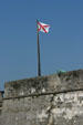 Burgundy Cross flag of first Spanish Colonial period in Florida over Castillo de San Marcos. St Augustine, FL.