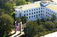 Flag hangs before building in state capitol complex seen from above. Tallahassee, FL.