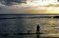 Fishing native-style during sunset at Paradise Cove. Oahu, HI.
