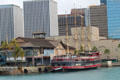 M/V Kulamanu four-masted passenger tour ship docked at closed Hawaii Maritime Center against Honolulu skyline. Honolulu, HI.