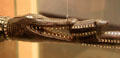 Detail of carved wood ceremonial staff of crocodile eating a pig from Solomon Islands at Honolulu Academy of Arts. Honolulu, HI.