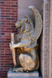 Lion griffin beside door of Merchants' National Bank. Grinnell, IA.