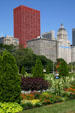 Red CNA Plaza, McCormick, & Metropolitan buildings over gardens of Grant Park. Chicago, IL.
