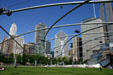 Skyscrapers along Michigan Av. & Randolph St. seen through latticework trellis covering of lawn seating area for Gehry's Pritzker Pavilion in Millennium Park. Chicago, IL.