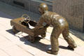 Sculpted boy pushing pedal car by Georgia Gerber on Douglas Street. Wichita, KS.