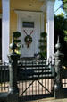 Townhouse with round cast iron gate posts in Garden District. New Orleans, LA.